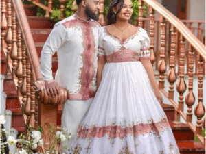 Glamorous Light Pink Habesha Wedding Outfit with Matching Couple Design